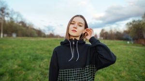 young confident woman standing outside